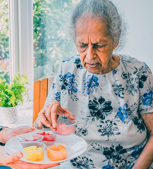 Elderly Woman With A Pack Of Jelly Drops Sweets